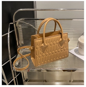Detail of khaki PU leather bag featuring diamond quilted pattern and gold hardware