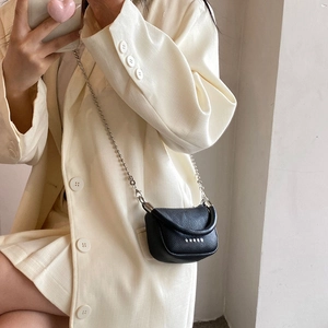 Mini black crossbody bag in lychee texture with star decor and silver chain strap