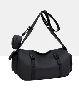 Detailed view of black nylon crossbody bag with adjustable buckle and small detachable coin pouch