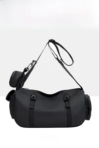 Detail of black sports bag with adjustable shoulder strap and small detachable coin purse