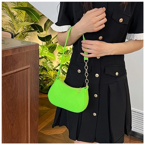 Neon green faux leather shoulder bag featuring a half-moon shape and gold chain strap