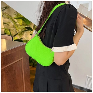 Detailed view of the neon green felt underarm bag featuring sleek minimalist quilting