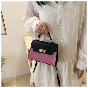 Detail showing the pink glitter panel and golden twist lock on this fashion handbag