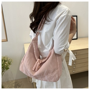Pink fabric hobo bag detail with pleated texture and thick braided rope zipper charms