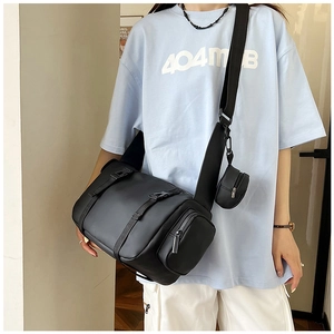 Side view of a black cylindrical sports bag with a small matching round accessory pouch