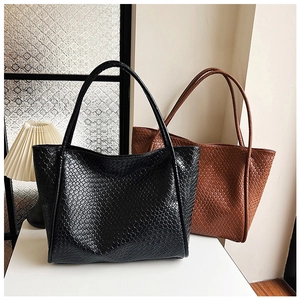Detail view of woven texture on retro tote bags in black and vintage brown colors