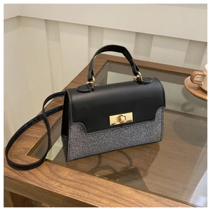 Detail view of small square crossbody bag with silver sequins and gold metal lock