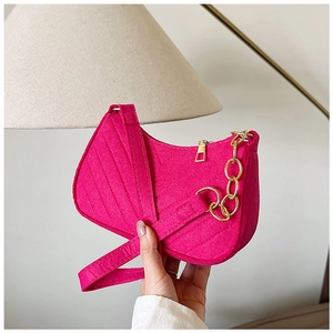 Detail of rose red felt hobo bag showing V-quilted texture and gold metal chain strap