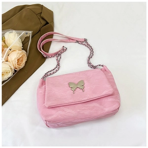 Close-up of pink pleated PU shoulder bag featuring a silver metal butterfly ornament