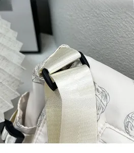 Detailed close-up of the black D-ring connector and durable strap on the printed nylon tote bag