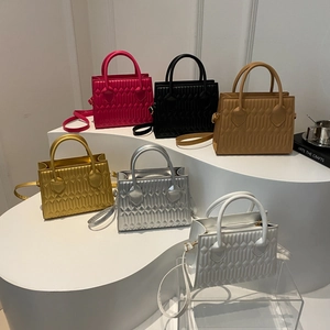 Quilted geometric texture shoulder bags in six vibrant colors displayed on white steps