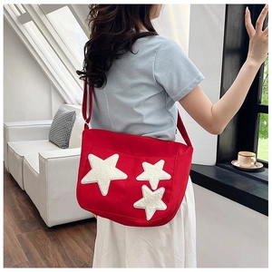 Détail du sac cabas en toile rouge avec étoiles scintillantes et bandoulière réglable