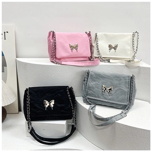 Detail of butterfly clasp and pleated texture on chain shoulder bags in four colors
