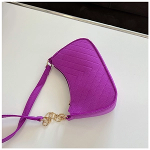 Detailed top view of purple felt shoulder bag with V-shaped quilting and gold chain links