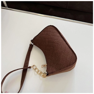 Detail of coffee brown felt shoulder bag featuring chevron quilting and gold chain strap