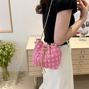 Chic pink bubble texture bucket bag with gold chain strap and pearl drawstring accents