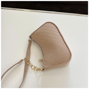 Detail of felt baguette bag with chevron stitching and gold metal chain strap
