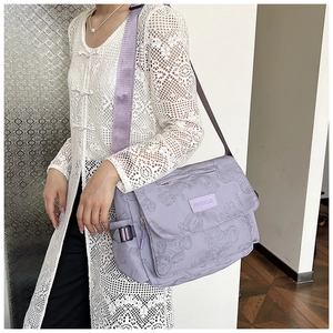 Detail of light purple nylon tote bag with bear print and adjustable wide shoulder strap