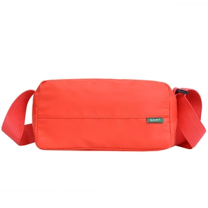 Red nylon pillow crossbody bag with wide shoulder strap and green woven logo label