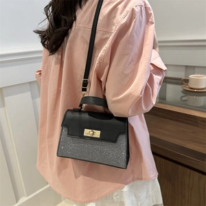 Minimalist silver contrast crossbody handbag with gold buckle closure and top handle