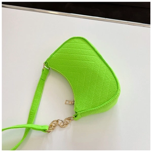 Detail of neon green felt shoulder bag with textured surface and gold chain accents