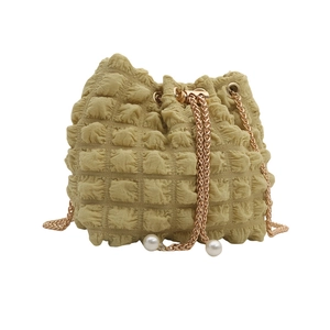 Mustard yellow popcorn texture drawstring bucket bag with gold chain and pearl accents