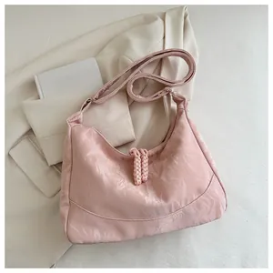 Detail of pink crescent hobo bag with unique pleated texture and braided knot detail
