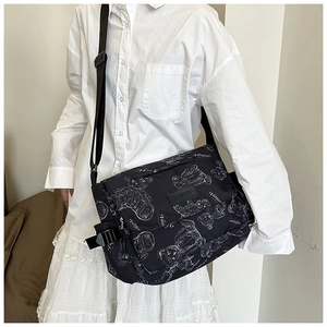 Detail of the high-density nylon messenger bag featuring hand-drawn bear pattern prints