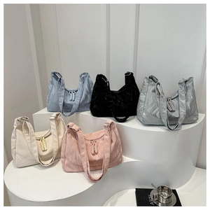 Minimalist textured tote bags in five colors with stylish woven zipper pulls and wide straps