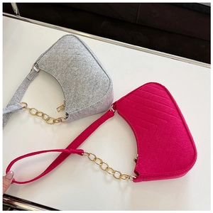 Detailed comparison of dark grey and magenta felt underarm bags with V-shaped quilting