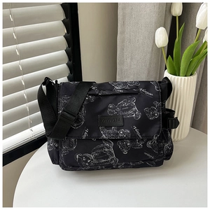 Detail of nylon crossbody bag with white bear prints and adjustable shoulder strap