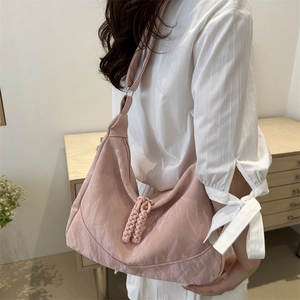 Pink crescent shoulder bag with marble texture and woven rope zipper detail