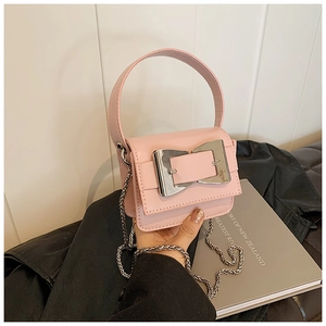 Pink mini square bag with large silver buckle and chain strap on a black leather jacket