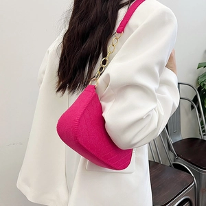 Vibrant hot pink felt shoulder bag with gold chain strap and diamond stitching