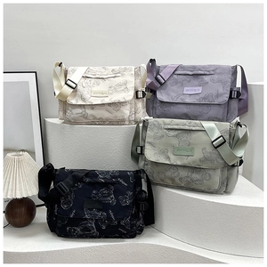 Detail view of colorful nylon messenger bags with bear print and adjustable straps