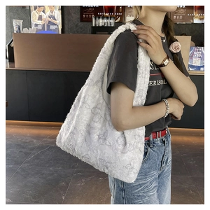 Detailed close-up of a white tote bag with lace butterfly patterns in a cafe setting