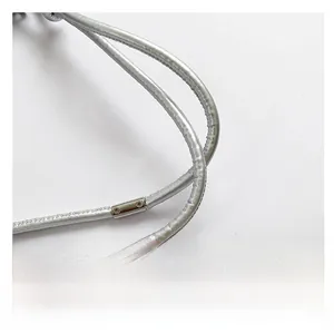 Detail of silver sequin bag featuring a comfortable metallic shoulder strap and connectors
