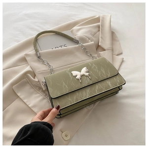 Detail of light green marble texture bag with silver butterfly clasp and layered design