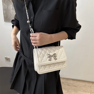 White quilted shoulder bag with silver bow accent and chain strap for women