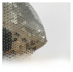 Macro shot of silver sequins on a trendy shoulder bag with shimmering metallic texture