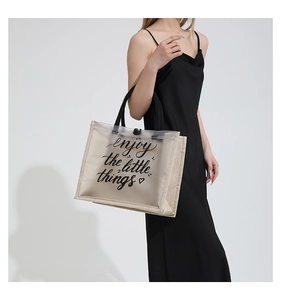 Detail of PVC and linen拼接 tote bag featuring the enjoy the little things slogan print