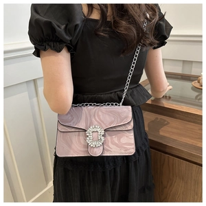 Detail of pink marble pattern crossbody bag with rhinestone buckle and chain strap