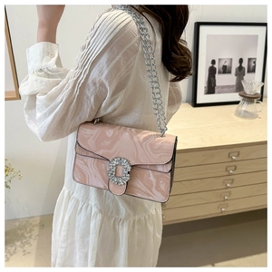 Detail of pink marble pattern bag with rhinestone buckle and silver chain on model