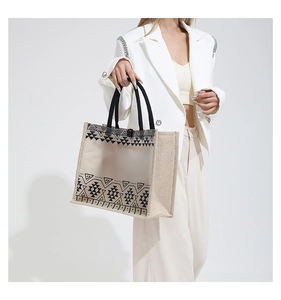 Detail of transparent tote bag with black tribal pattern and woven rope handles