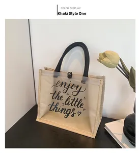 Detail of canvas and clear PVC tote bag with Enjoy The Little Things text print