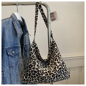 Detailed view of the leopard print canvas tote bag showing textured jacquard fabric