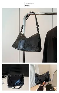 Detail view of black sequined underarm bag with unique knotted leather strap design