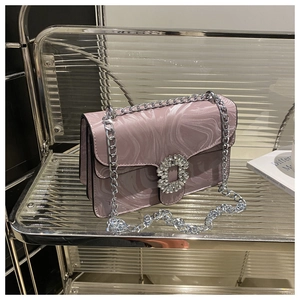 Close-up of pink marble pattern crossbody bag with luxury rhinestone buckle and chain
