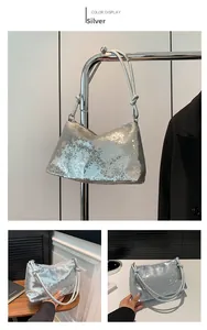 Detail view of silver sequin shoulder bag featuring sparkling texture and knotted straps