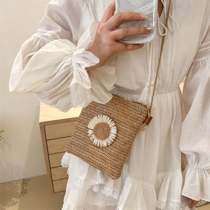 Straw crossbody phone bag with sunflower decor and white lace dress for summer